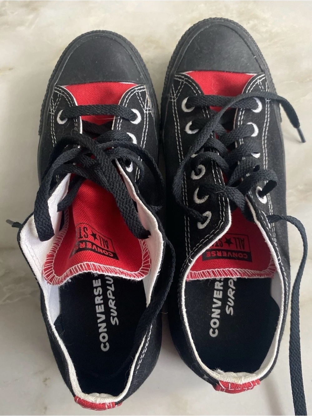 Converse Womenโs Black Canvas Low-Top Sneakers with Red Tongue